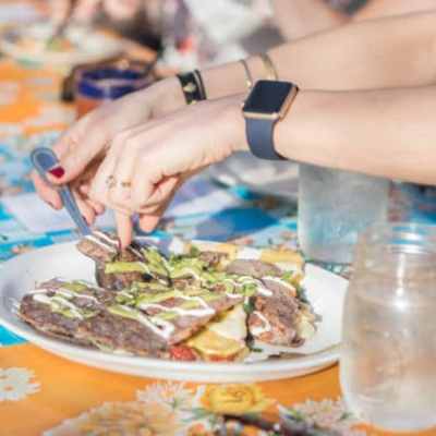 a person sitting at a table with food