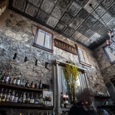 a group of people in a room next to a fireplace