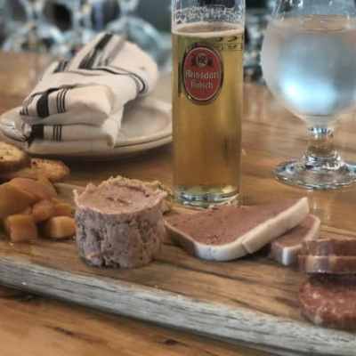 a glass of wine sitting on top of a wooden table