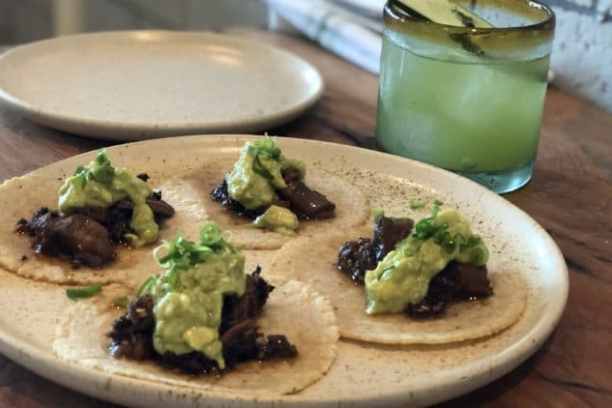 a plate of food sitting on top of a wooden table