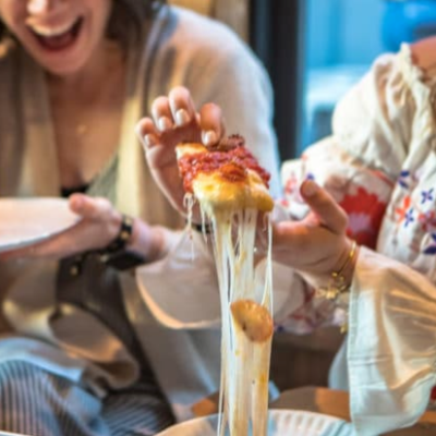 a woman sitting at a table eating food